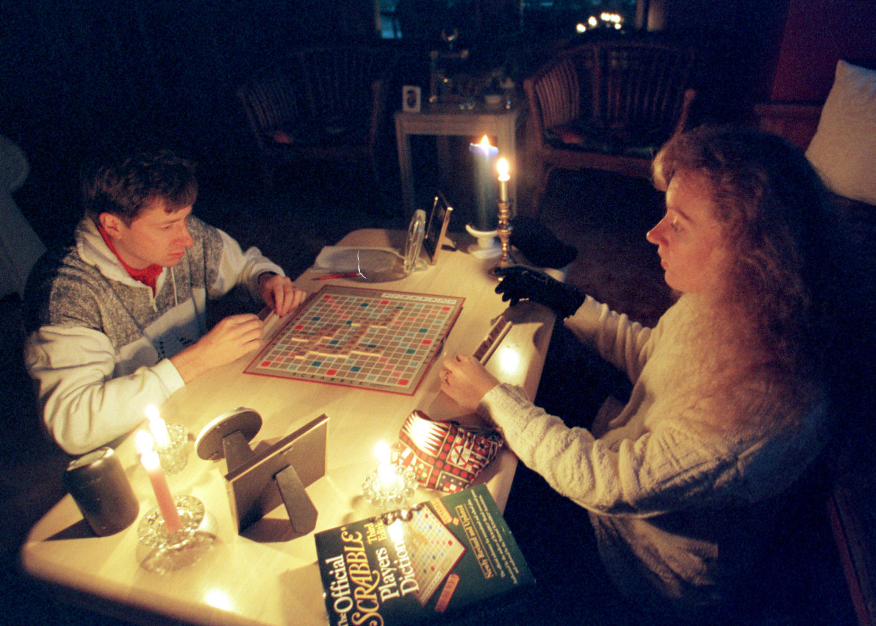 Steve and Julian Adair play Scrabble by candlelight Sunday, Oct. 27, 1997, in their home near 60th and Blondo Streets.